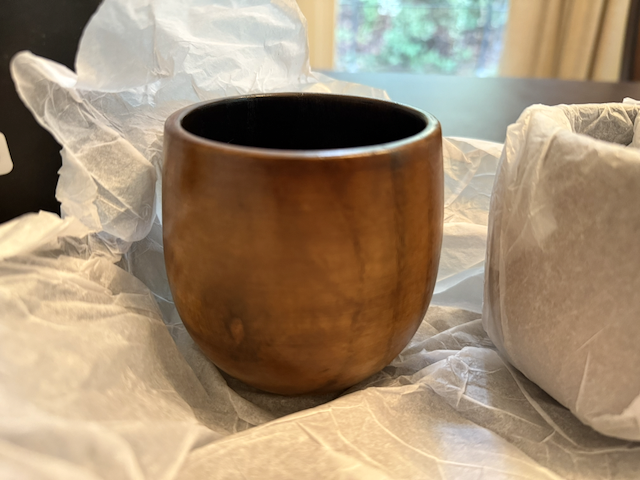Wooden bourbon cup beside a Bourbonado-branded tube